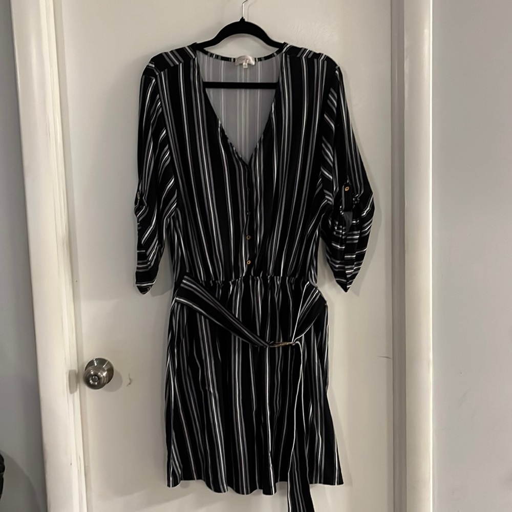 Black and white striped dress with circle tie belt and button up sleeves.